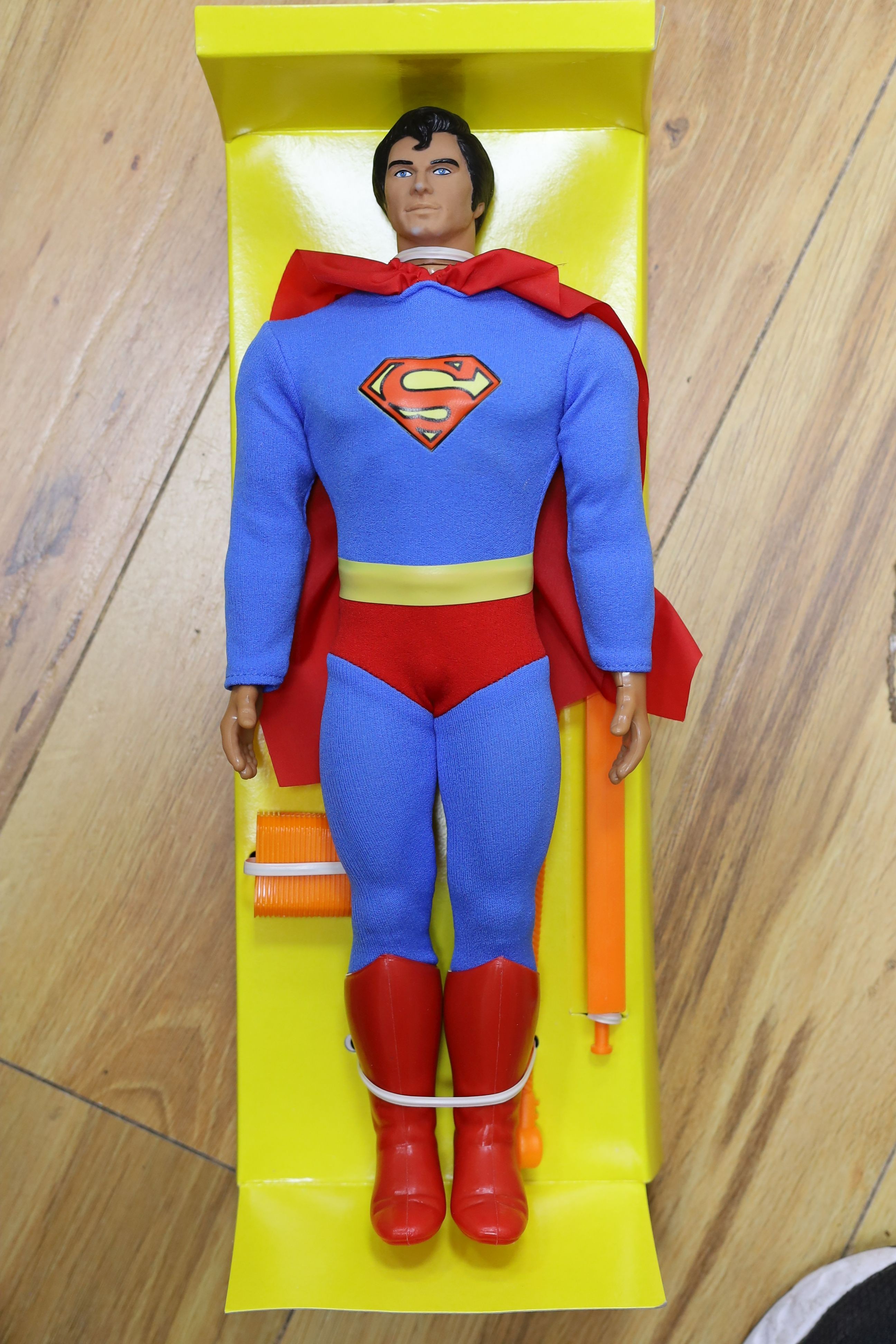 A Denys Fisher Superman, rare in original box, another unboxed, a Unigate milk float with bottles, and a boxed Evel Knievel Stunt Cycle